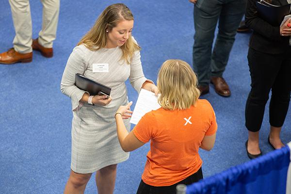 recruiter and student talking at career fair